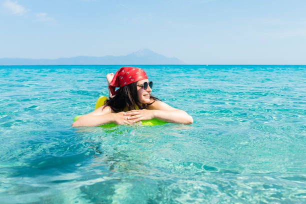 istock Woman floating on water on inflatable bed. 1743581783