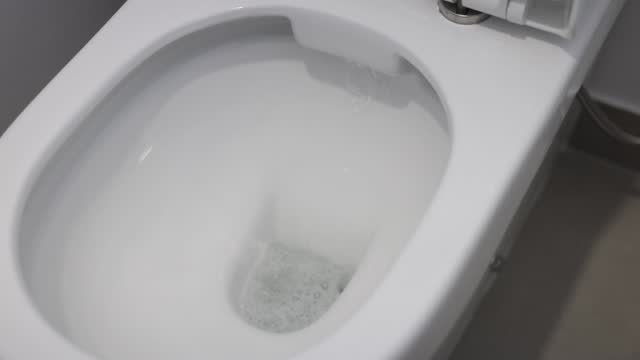 Slow Motion Flushing Toilet with Water Splashing