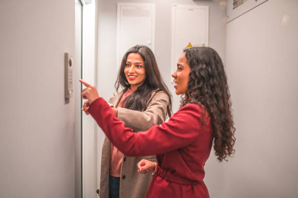 istock Young Female Hotel Guest With Assistant Explaining Her the Smart Lock 1743625621