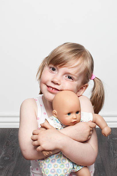 istock Pretty girl hugging her doll 174363344