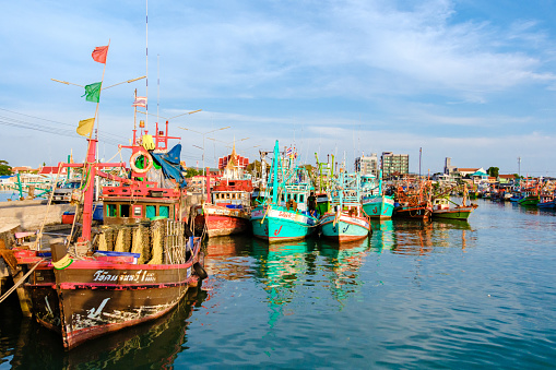Bangsaray Pattaya Thailand May 2023, fishing harbor at the fishing village Bangsaray during sunset with colorful wooden fishing boats