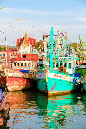 Bangsaray Pattaya Thailand May 2023, fishing harbor at the fishing village Bangsaray during sunset with colorful wooden fishing boats