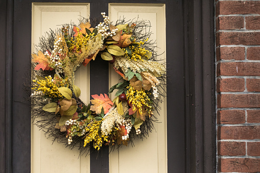 Autumn wreath decorating front door.