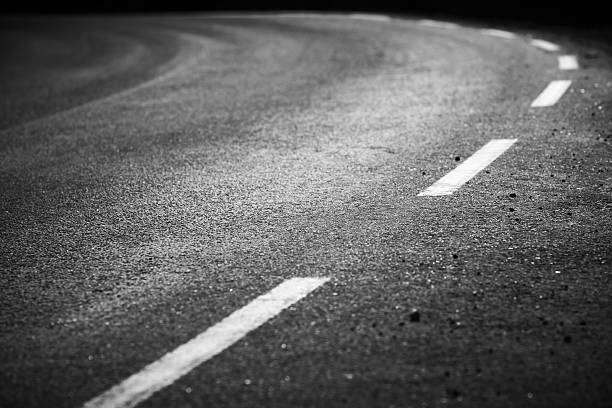 istock Turning asphalt road with marking lines and tire tracks 174365765