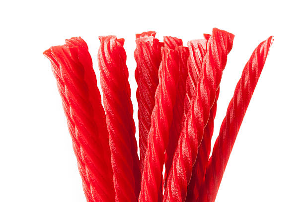 Bright Red Licorice Candy Bright Red Licorice Candy shaped like a twisted rope chewy stock pictures, royalty-free photos & images