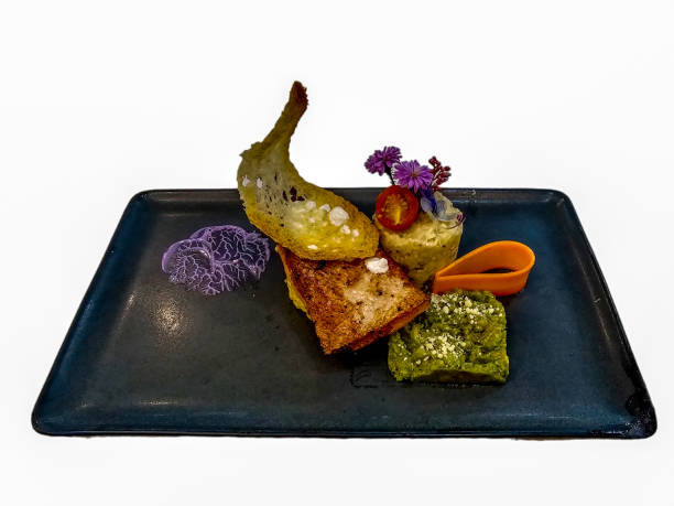 istock Salmon Steak with Mashed Potatoes, Mashed Avocado and Crispy Bread Decorate with vegetables and flowers on black plate. Isolated on white background. 1743675281