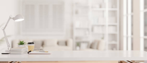 istock A white tabletop with copy space against a blurred modern white living room in the background. 1743681845