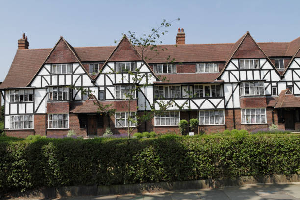 Mock tudor housing estate design 1930 This is one of 18 blocks of flats built in mock Tudor style between 1928 and 1936. It is the Hanger Hill Garden Estate in Ealing, London W3. It is sometimes known as the Tudor Estate. Tudor buildings feature a white facade with prominent wooden beams picked out in black or brown. Historically, the real Tudor period in England extends from 1485 to 1603. Architecture harking back to such times shows a real affection for and appreciation of the past. eanling stock pictures, royalty-free photos & images