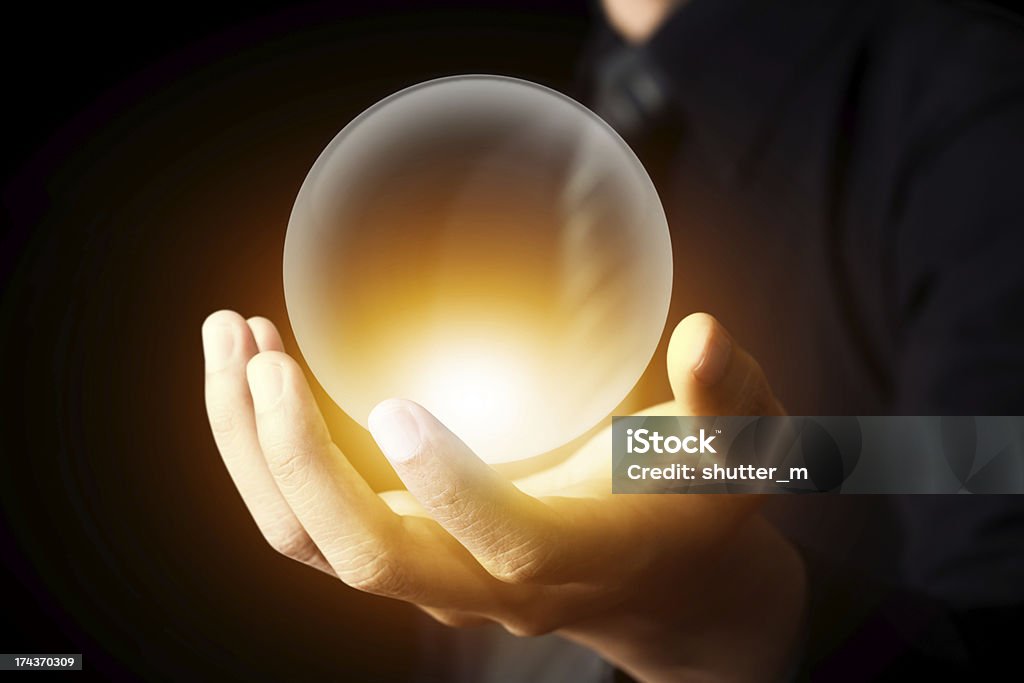 Businessman hand holding a Crystal Ball Crystal Ball Stock Photo