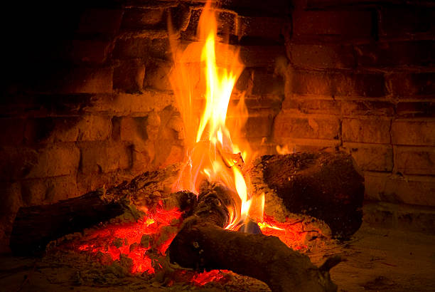 Warm fire in a fireplace stock photo