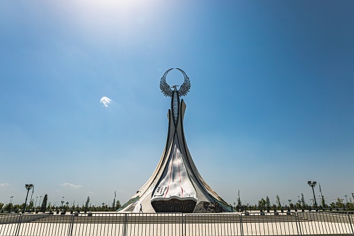 Tashkent, Uzbekistan - August 28, 2023: Memorial of Freedom and Independence with the structure of the national color on the square of the city park New Uzbekistan (Yangi Uzbekistan) with a tower where the Humo bird.