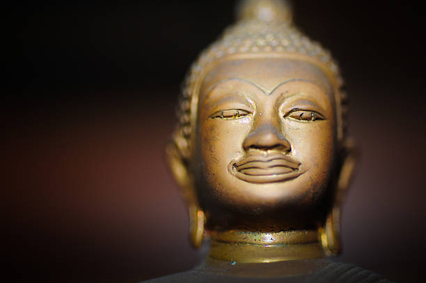 istock Buddha golden sculpture on lightened gold background 174371773