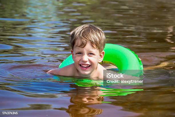 Boy Swimming In Water Stock Photo - Download Image Now - Inflatable Swim Ring, River, 2-3 Years