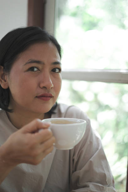 istock Close-up woman sitting drinking coffee 1743788997