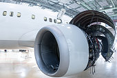 Close-up of an open high bypass turbofan airplane engine of a passenger aircraft in a hangar