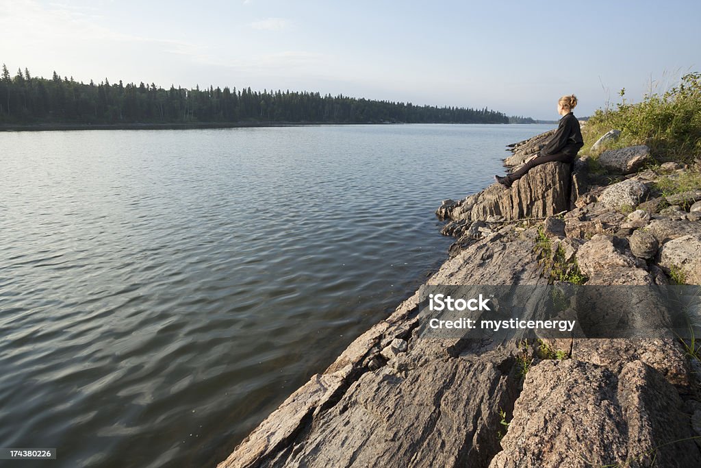 Paint lake Provincial Park Young teen sits over looking Paint Lake, Paint Lake Provincial Park, Northern Manitoba. Precambrian Shield. 14-15 Years Stock Photo