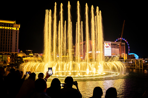 Las Vegas. USA. 10.25.2023. Beautiful view of Bellagio Hotel casino with fountains creating magical ambiance against backdrop of evening sky.