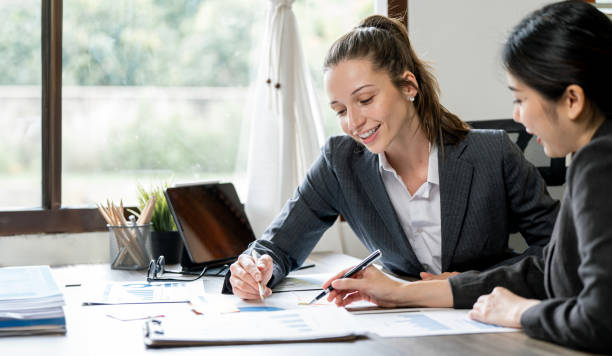 istock Working together on project. Two young business colleagues working on computer 1743813338