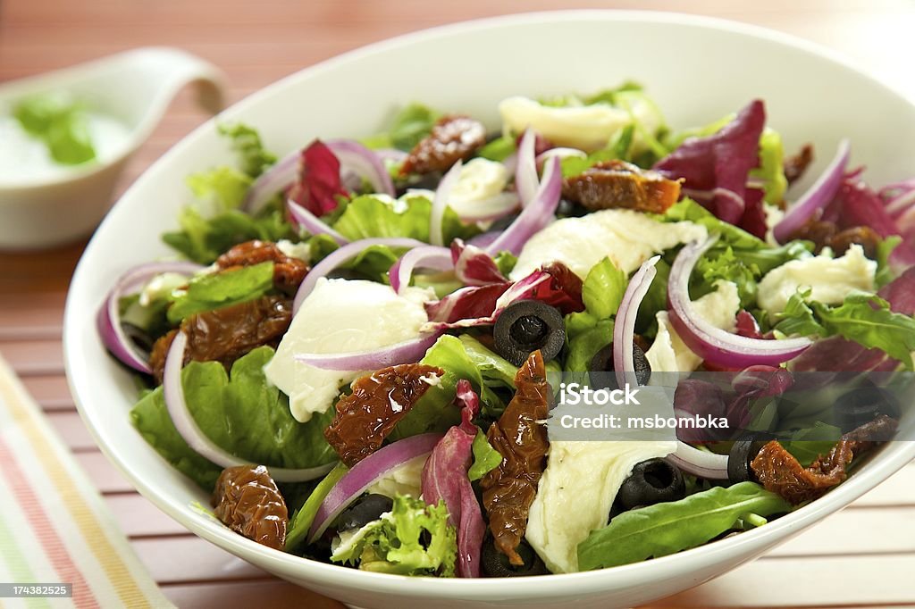 Salad with cheese, tomato and onion Bowl Stock Photo