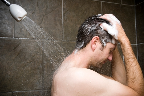 Man Showering, Water Washing Over Him