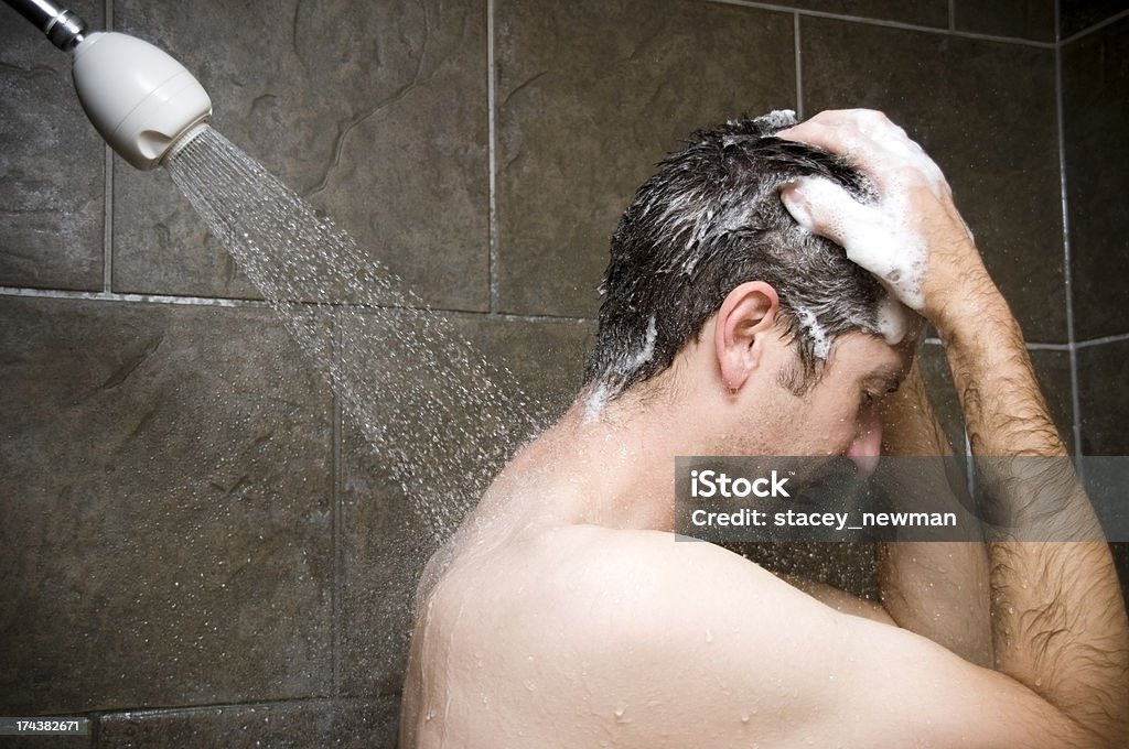 Man Showering, Water Washing Over Him Men Stock Photo