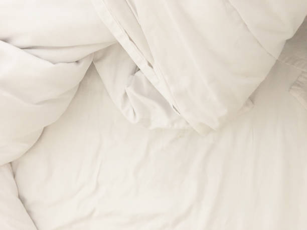 istock Unmade bed; wrinkled pillowcases, bed sheet and duvet 1743835344