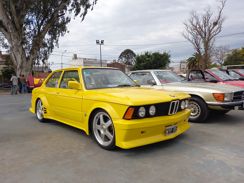 Lanús, Argentina - Sept 24, 2023: Old sporty yellow German executive compact 1970s BMW 3 Series 320 Alpina coupe two door. Classic car show.