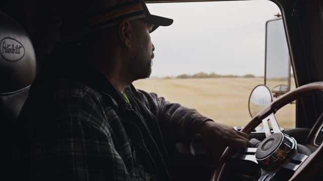 Trucker driving his semi along a rural highway