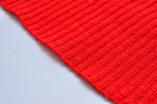 red wool knitted yarn texture, woolen fabric on white background