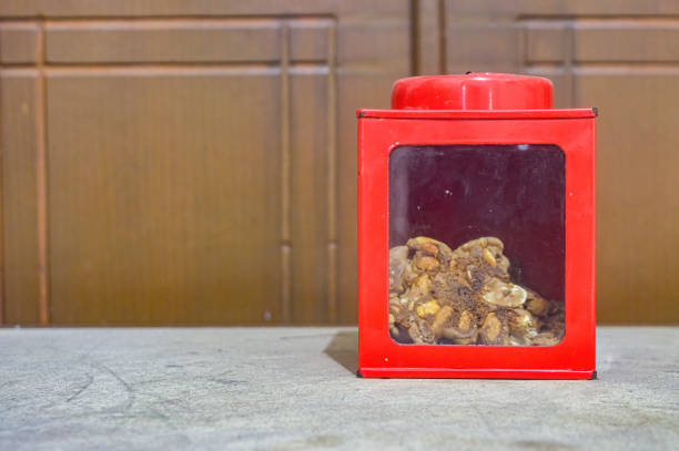a classic red iron jar with glass showing the snacks inside