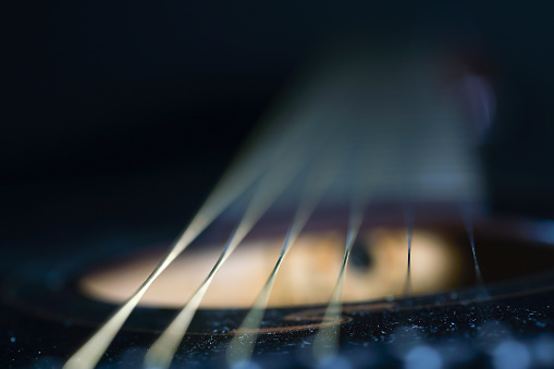 Electrical guitar headstock, machine heads and metal strings closeup. Electric guitar black and white color, detail. Music instruments. Concept international music day. Macrophotography. Soft focus