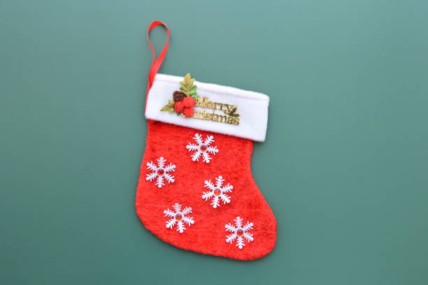 istock red wool winter sock on green background, christmas decoration 1743860949