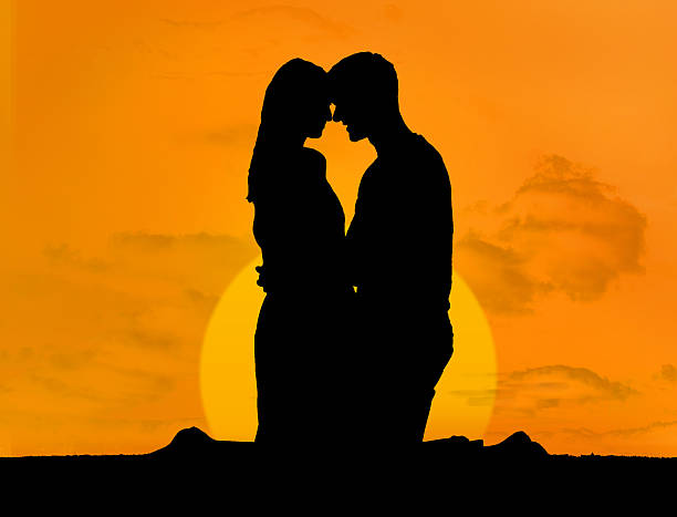 istock Silhouette of couple embracing under a sunset 174386243