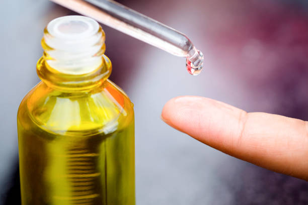 istock Dropping serum collagen moisturizer of face into clear yellow bottle soft light background. Protector skin Treatment facial essence oil, Vitamin C. Beauty and spa Concept 1743863641