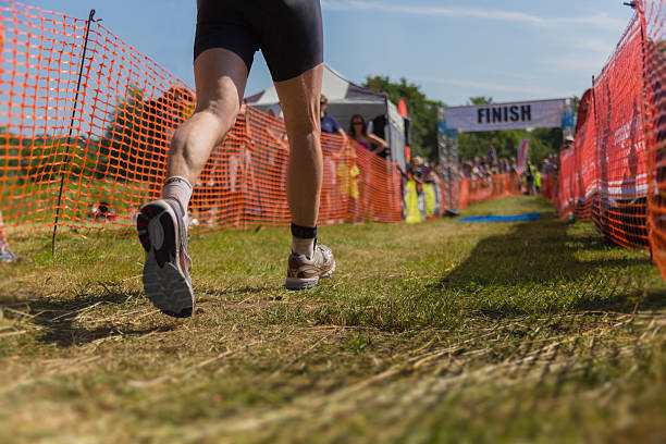 Triathlete runner finish line stock photo