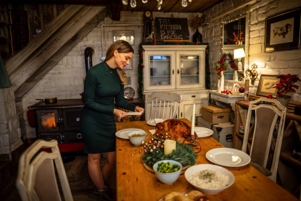 istock Woman setting up and decorating a dining table for a Christmas dinner 1743908267