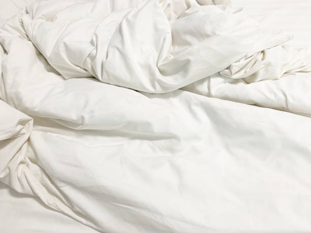 istock Unmade bed; wrinkled pillowcases, bed sheet and duvet 1743910581