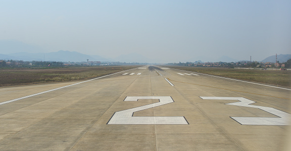Empty runway of international airport in sunny day.