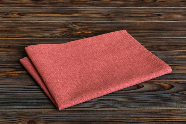 istock top view with red empty kitchen napkin isolated on table background. Folded cloth for mockup with copy space, Flat lay. Minimal style 1743946468