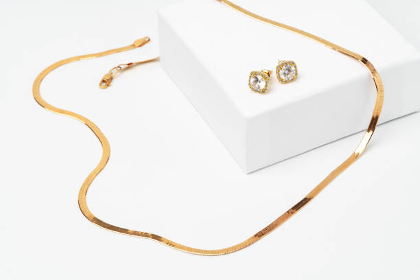 istock Golden diamond neacklace and earrings on white background 1743951131