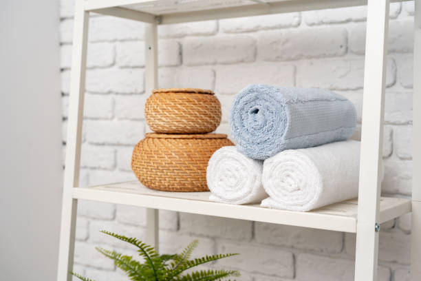 istock Rolled fluffy towels on shelf in bathroom 1743964844
