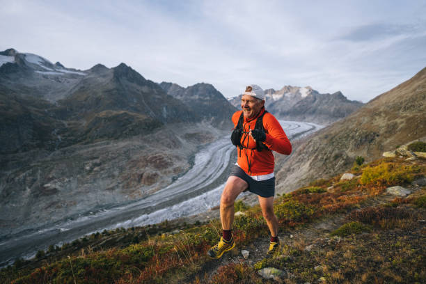 istock Senior male trail runner bounds along mountain trail 1743971946