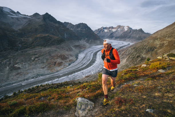 istock Senior male trail runner bounds along mountain trail 1743971951