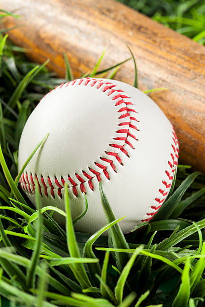 istock New White Baseball in green grass 174397447