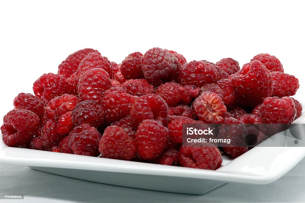 Raspberries Raspberries on a plate in front of a white background. Berry Fruit Stock Photo