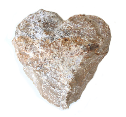 naturally heart from nature grey textured stone isolated on a white background for earth day, stoneheart, mother´s day, father´s, children day, family day with place for text on the heart or the background