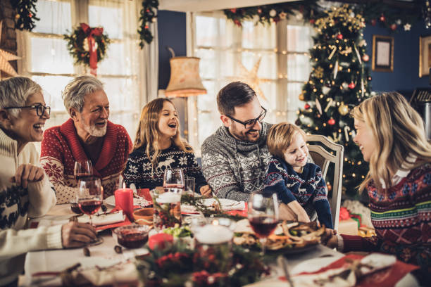 istock Happy multi-generation family having fun during New Year's lunch at dining table. 1744005604