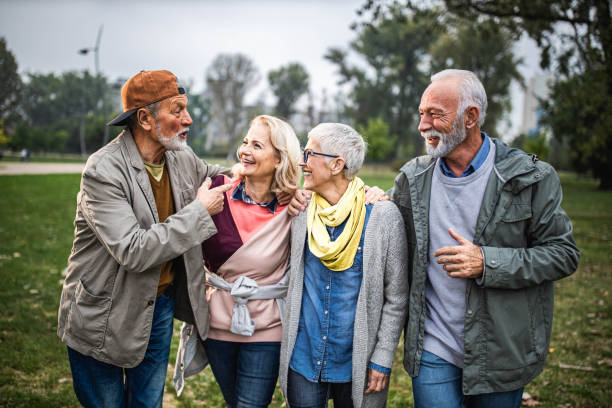 istock Happy seniors talking while walking embraced in nature. 1744016431