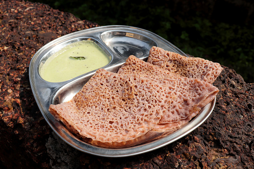 Ragi Ghavne and chutney, or Neer Dosa, is a popular breakfast dish from the Konkani or South Indian cuisine. Ghavne is a thin and delicate raagi crepe served with spicy coconut  chutney.