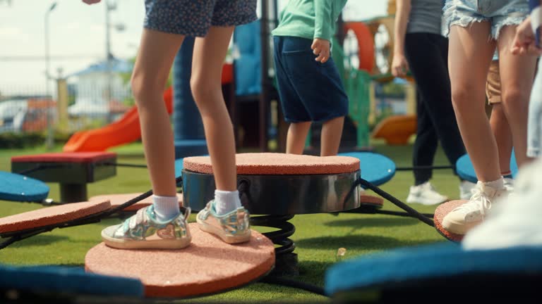 Happy children practices the balance equipment before morning exercise class at an international school.